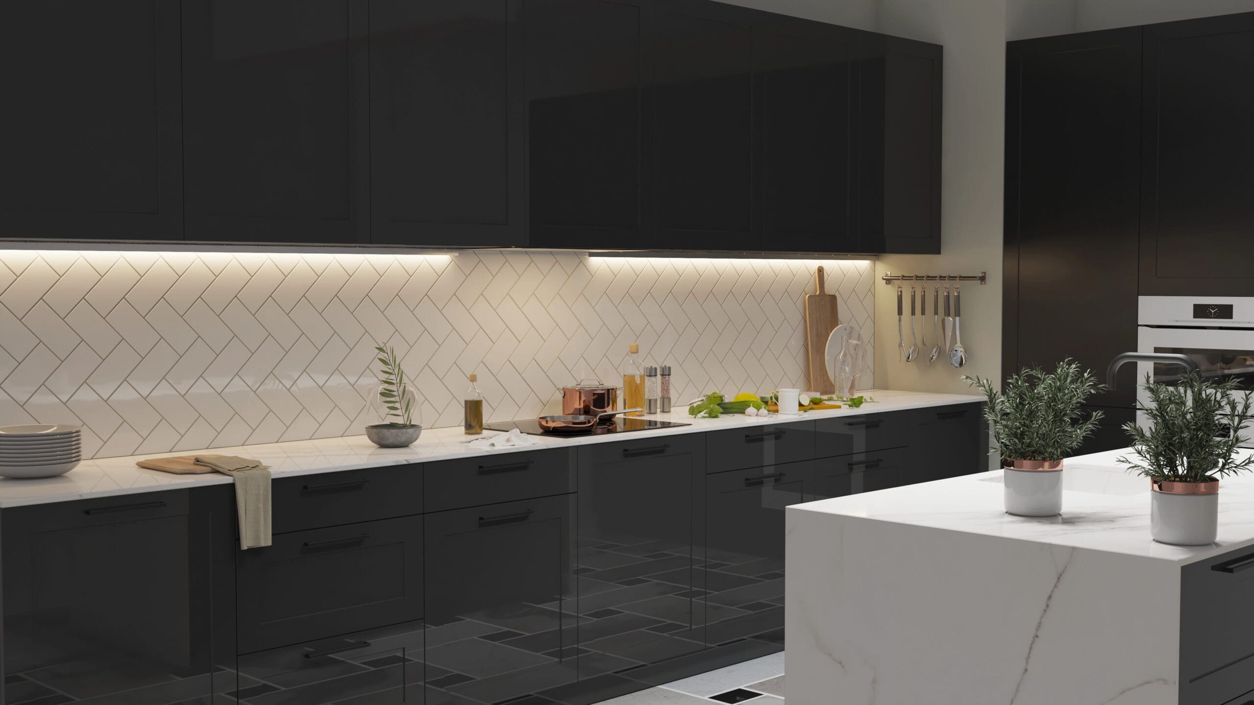 A modern kitchen with black cabinets, white countertops, and a white subway tile backsplash. Under-cabinet lighting illuminates the counter, which displays various cooking items and utensils. A white island with two potted plants stands in the foreground.